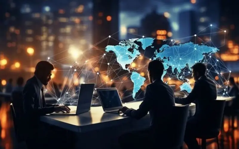 group of people using laptop with a map infront