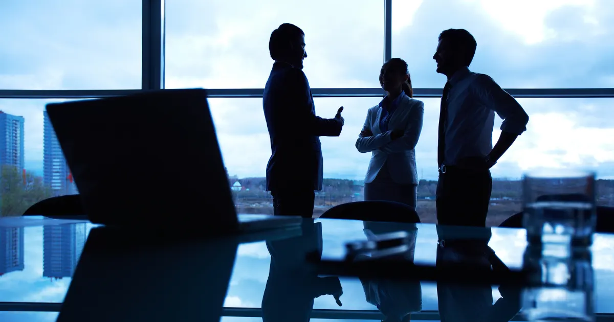 business people silhouetted against a city skyline